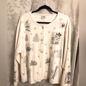 Christmas sweater jacket. Creamy white with snow scenes decorating the front.